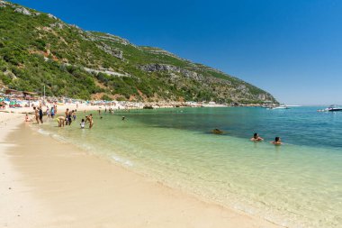 Güneşli bir günde Setubal, Lizbon, Portekiz yakınlarında turistlerle sahile güzel bir manzara.