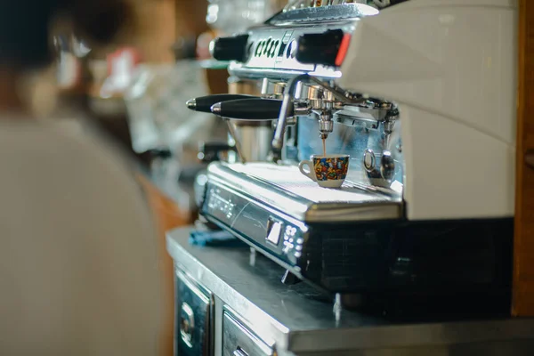 Italian espresso machine on a counter in a restaurant dispensing