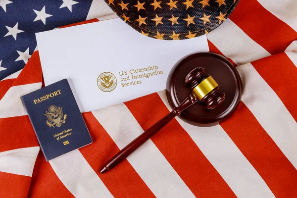 US passport over Letter from U.S. Citizenship and Immigration Services of naturalization with in a judge law gavel