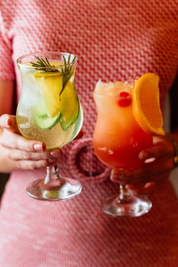 Parlak yaz alkollü kokteyller bir kızın ellerinde.