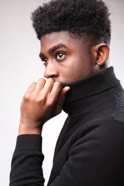 Handsome brunette man posing in black turtle neck sweater