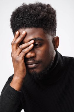 Multiracial handsome brunette man posing in black turtle neck sweater