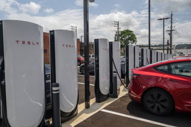 Tesla EV charging station with cars.