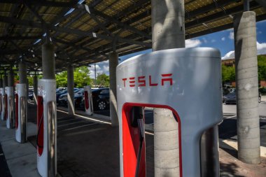 A Tesla EV charging station in a parking lot.