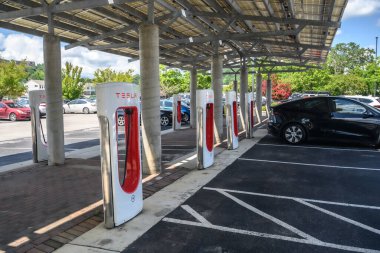 A Tesla EV charging station in a parking lot.