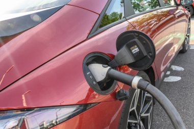 A car getting power at an EV charging location.
