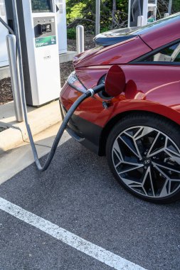A car getting power at an EV charging location.