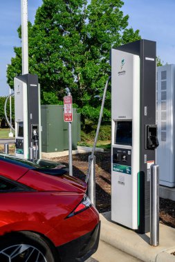 A car getting power at an EV charging location.