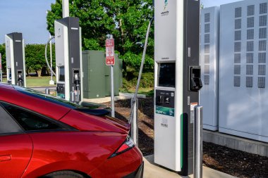A car getting power at an EV charging location.