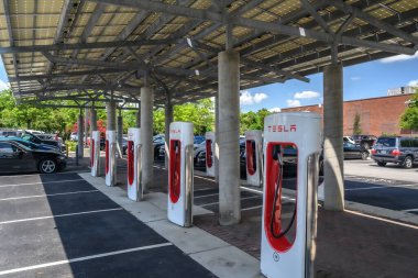 A Tesla EV charging station in a parking lot.