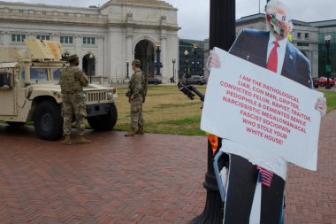Protest sign criticizing Trump near National Guard, Union Station