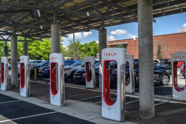 A Tesla EV charging station in a parking lot.
