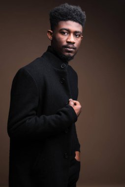 Close-up of African elegant man in black jacket looking at camera