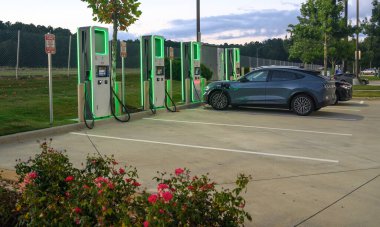 A car getting power at an EV charging location in a parking lot.