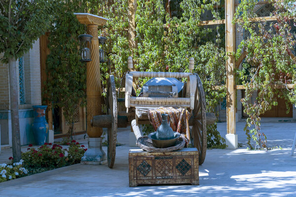 Rustic wooden cart decorated with cradle, wooden basket