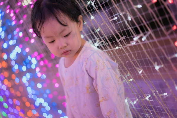 Baby girl with led lights background — Stock Photo, Image