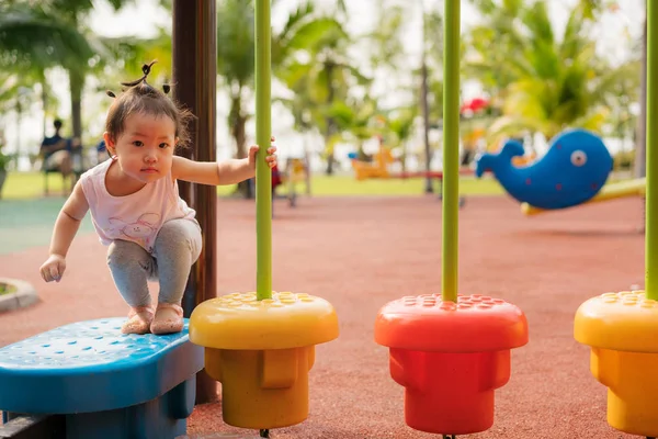 Baby girl playing at playground in the park. — Stock Photo, Image