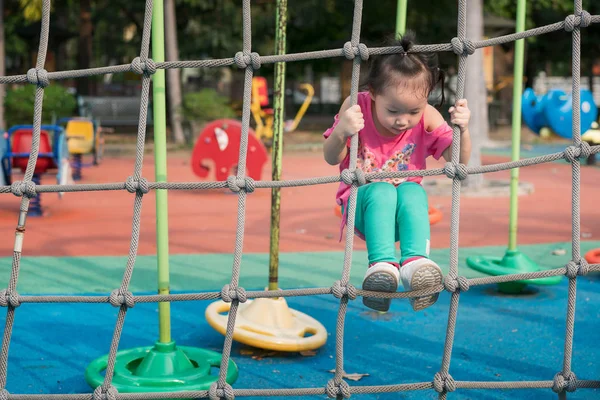 Children are climbing the net on the playground. — Stock Photo, Image