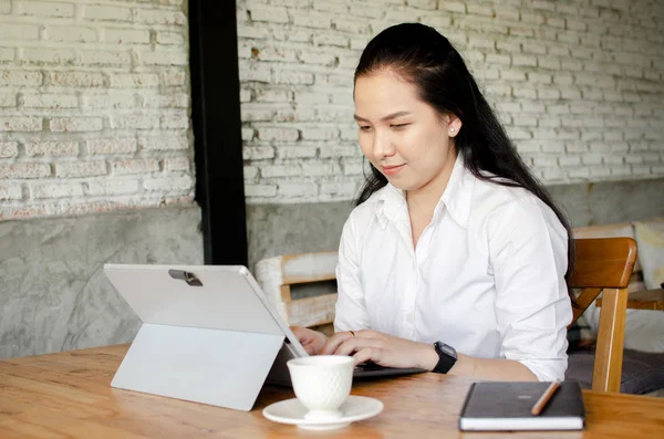 Jeune femme utilisant un ordinateur portable dans un café — Photo