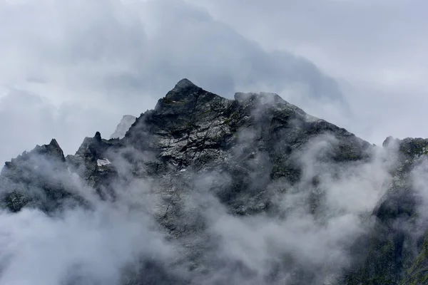 Peaked mountain peak in the fog. Dombay, Karachay-Cherkessey, Russia