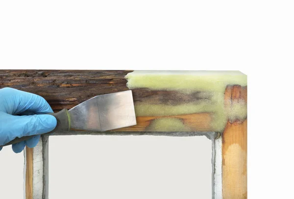 Person applying resin with spatula to old sash window — Stock Photo, Image
