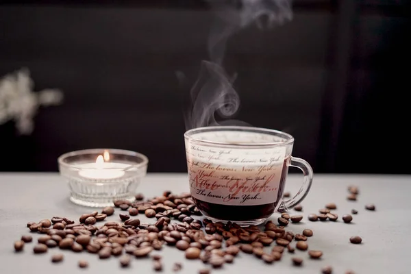 Cup of coffee with a candle on a table