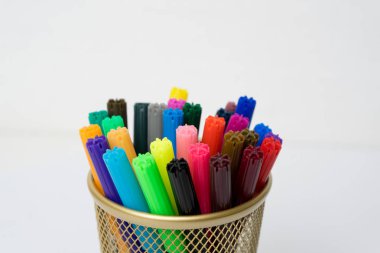 Kalem durumda beyaz arka plan üzerinde renkli işaretleyicileri izole