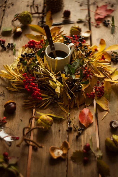 Autumn composition with Wreath,dry leaves gifts and berries/making autumn wreath