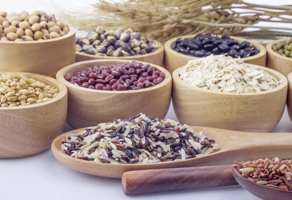 Cereal grains , seeds, beans on wooden background