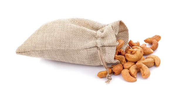 Cashew nuts in burlap sack isolated on white background Stock Photo