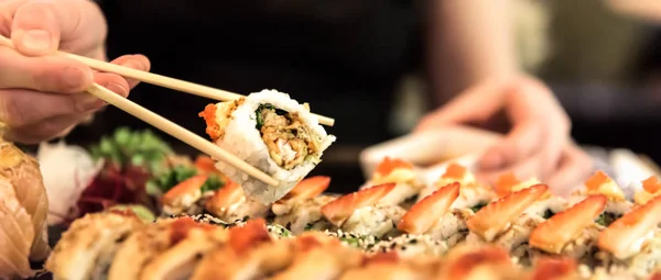 Photo of sushi rolls - Japanese food in restaurant - close-up image - banner