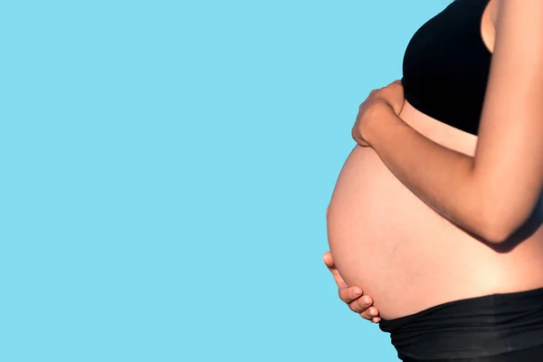 Vientre Mujer Embarazada Con Las Manos Fondo Azul —  Fotos de Stock