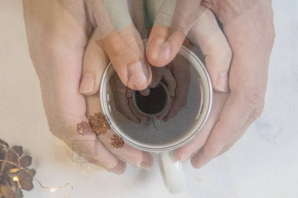 Couple in love holding hands with coffee on white marble table. Photograph taken from above, top view with copy space — Stock Photo, Image