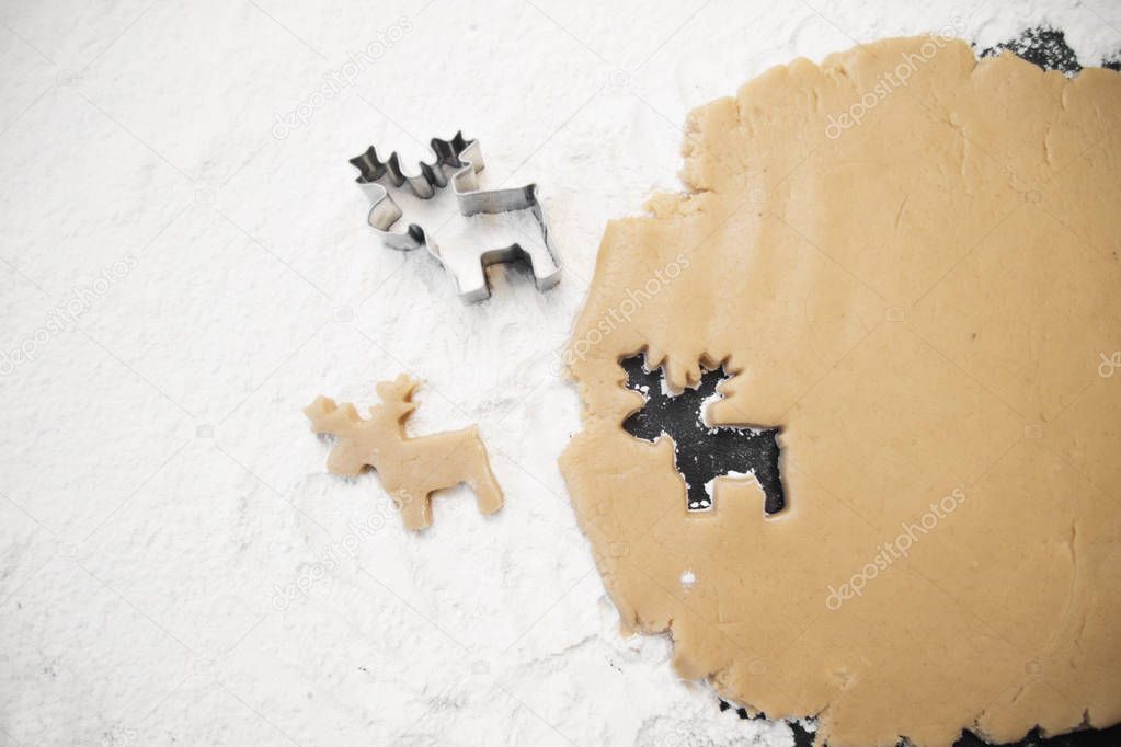 christmas gingerbread deer cookies with cutter , dough and rolling pin, full frame