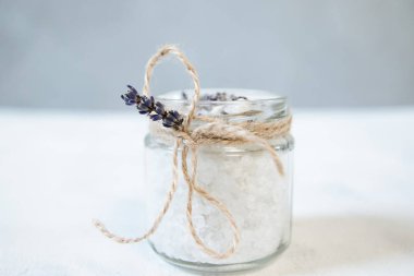 Natural herbal sea salt with aromatic lavender - perfect for relaxation. Cosmetic jars and bottles with salt, lavender flowers clipart