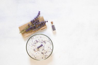 Natural herbal sea salt with aromatic lavender - perfect for relaxation. Cosmetic jars and bottles with salt, lavender flowers, bath bomb clipart