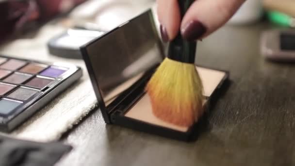 A palette with eye shadows and a makeup brush: womens cosmetics. Morning make-up. Decorative cosmetics: a palette with eye shadows, a brush.Evening make-up.Details of the make-up artists work. — Stock Video