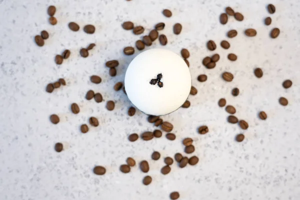 Bath bombs with coffee grains on a white background