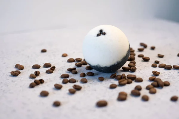 Bath bombs with coffee grains on a white background