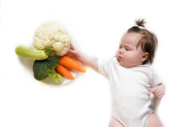 Lindo bebé y mezcla de verduras - brócoli, calabacín, zanahorias y coliflor en el fondo blanco — Foto de Stock