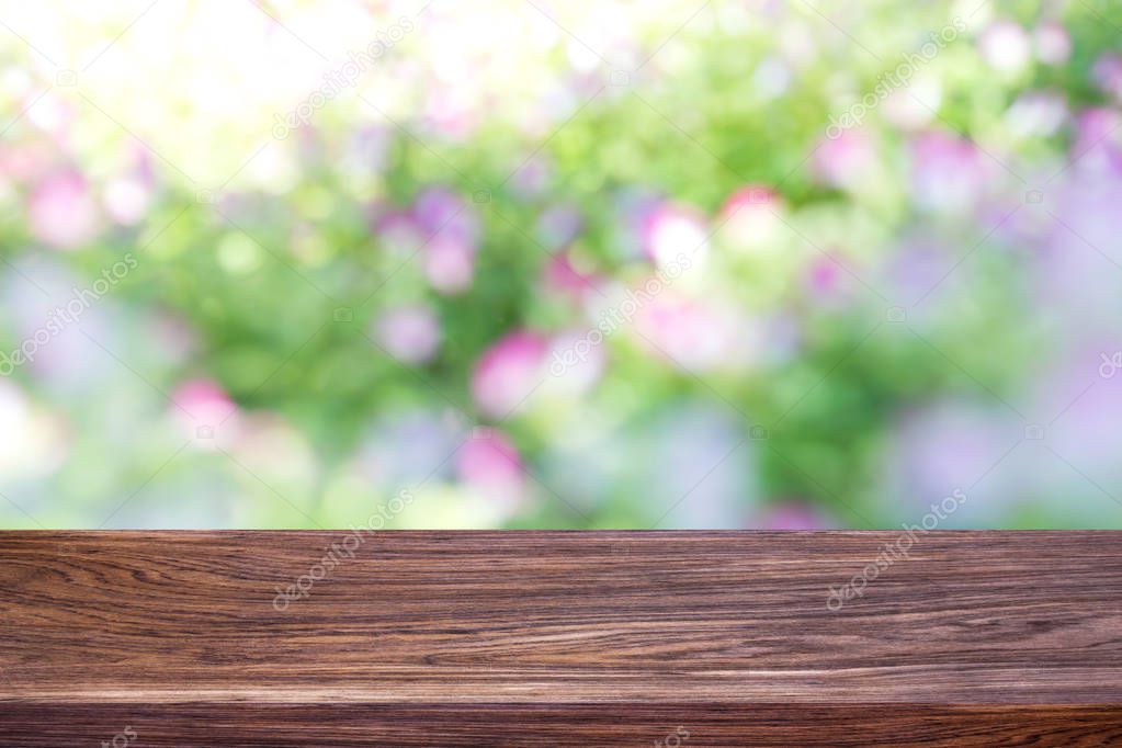 Wood table top on bokeh green bright background. For montage product display or design key visual layout.