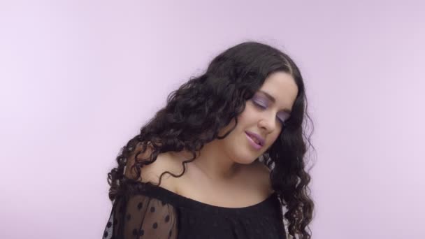 Zwart krullend haar plus size model met bruine ogen op Lila achtergrond met lila make-up — Stockvideo