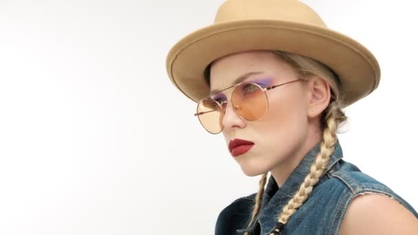 Modellek, kalap, két zsinór és szemüveg, úgy néz ki, mint egy cowboy lány — Stock videók