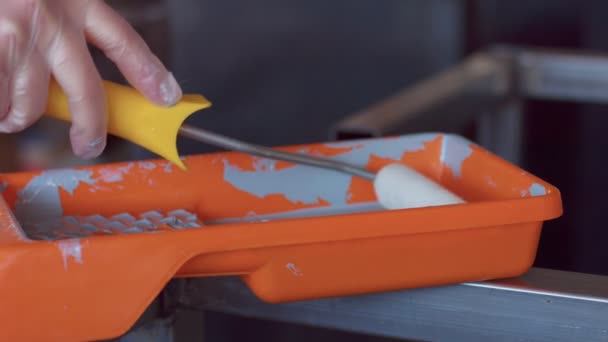 Closeup of paint busket with a fresh roller — Stock Video