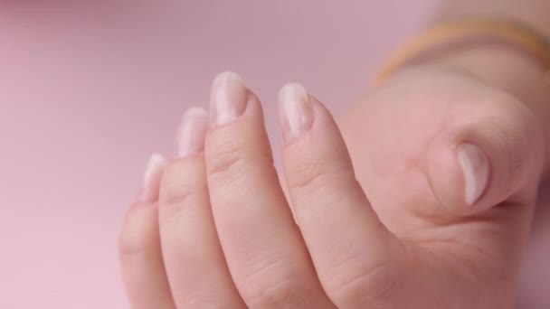 Close-up vrouw hand op roze maakt manicure voor zichzelf — Stockvideo