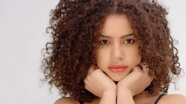 Mixed race black woman with freckles and curly hair closeup portrait with hair blowing — Stock Photo, Image