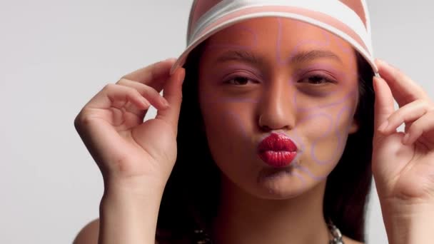 Mixed race asian model in studio creative art makeup — Stock Video