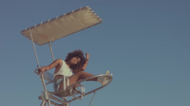 Mixed race black young woman outdoors, summer sunset light, beach zone of Barcelona — Stock Video