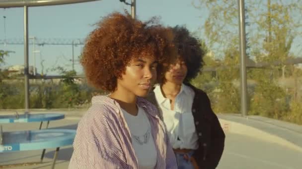 Portrait of two mixed race black women in the park at sunrise — Stock Video