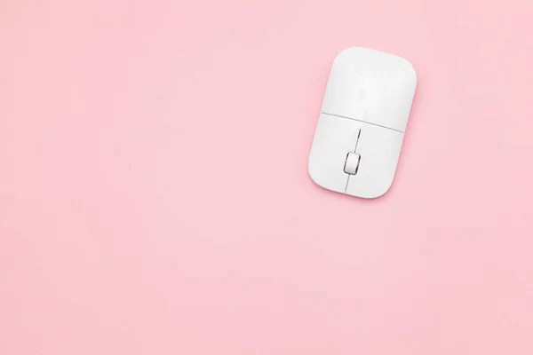 White wireless optical mouse with a wheel on a pink background. Modern concept for the Internet web site. Free space for input text, image, and logo. Mockup